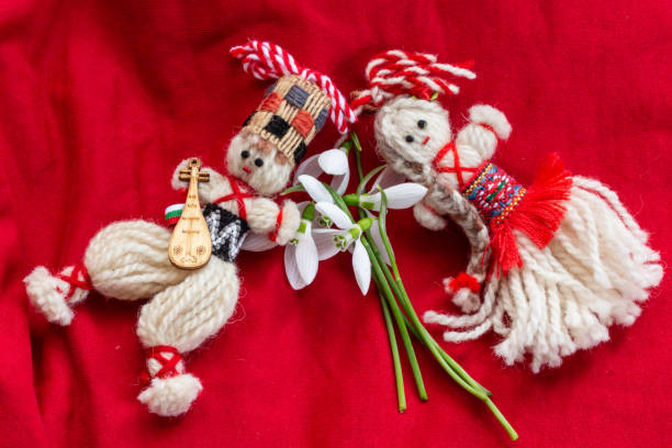 istock Martenitsa - traditional Bulgarian custom - red background with snowdrops 1303877794