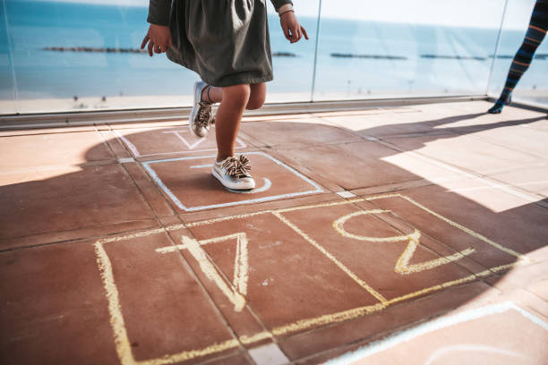 istock Kids playing hopscotch 1303877905
