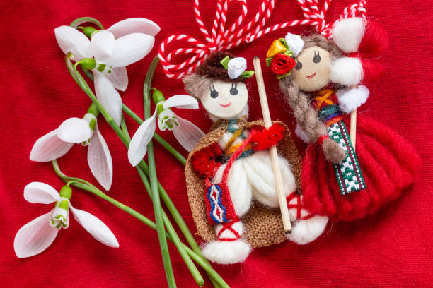 istock Martenitsa - traditional Bulgarian custom - red background with snowdrops 1303878461