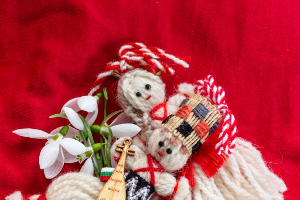 istock Martenitsa - traditional Bulgarian custom - red background with snowdrops 1303878553