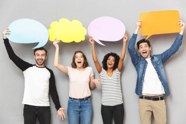 istock Emotional group of friends holding speech and thoughtful bubbles. 1303878663