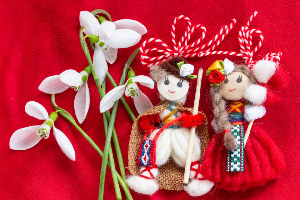 istock Martenitsa - traditional Bulgarian custom - red background with snowdrops 1303878832