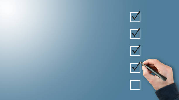person ticking checkboxes with marker pen on checklist or to-do-list with copy space