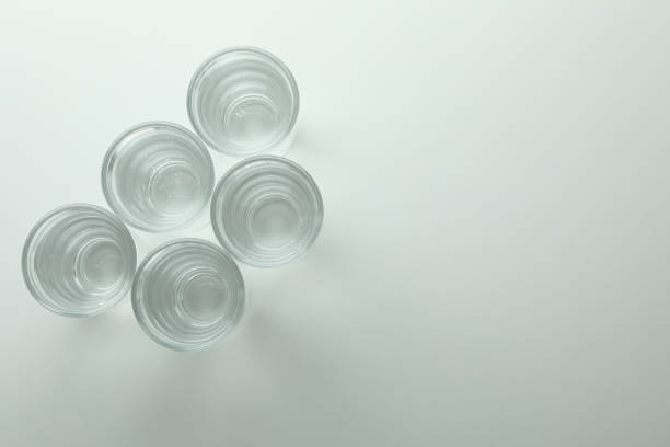 istock Shots of vodka or tequila on white background 1303881288