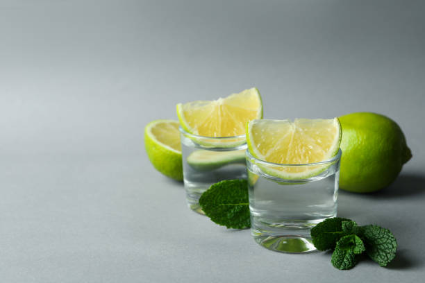 istock Shots, lime slices and mint on gray background 1303881416