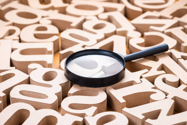 istock Magnifying glass on Wood Alphabets 1303881459