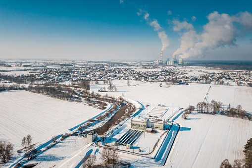 Aerial view of the water intake stations from the Mala Panew River for the Opole Power Plant between snow-covered fields.