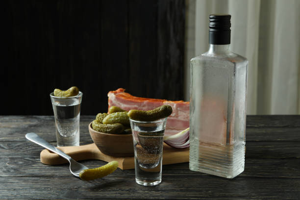 istock Vodka and tasty snacks on wooden table 1303881644