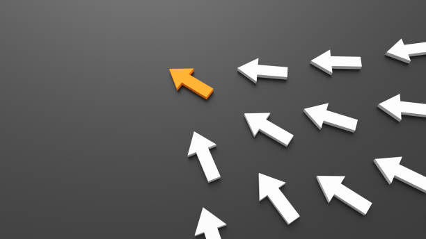 istock Leadership concept, orange leader arrow leading white arrows, on black background with empty copy space on left side 1303883023
