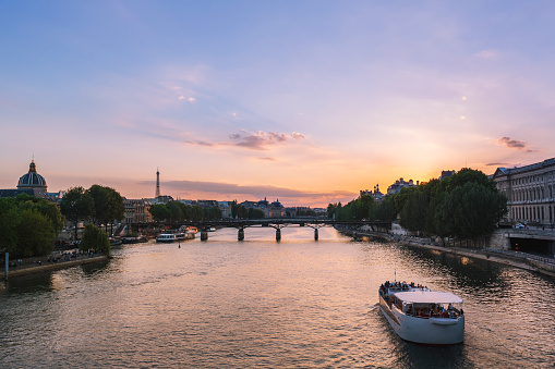 Seine river with tour-boat during sunset in Paris, France