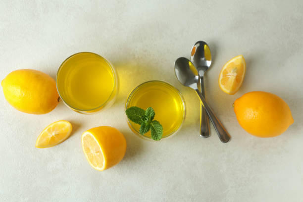 istock Concept of dessert with lemon jelly on white textured table 1303883936