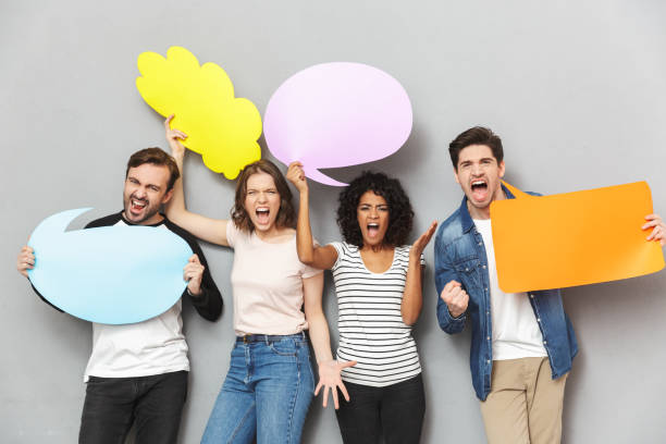 istock Screaming angry group of friends holding speech and thoughtful bubbles. 1303884646