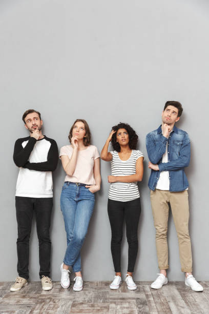 istock Thinking group of friends looking aside. 1303885446