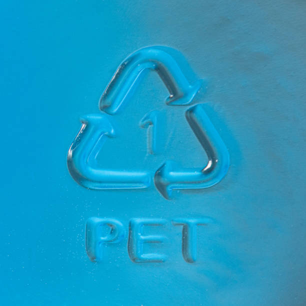 PET Recycling symbol on drinks bottle Close up of a recycling symbol around the number 1 to denote the recycling category for PET (Polyethylene Terephthalate) on the surface of a drinks bottle. polyethylene terephthalate stock pictures, royalty-free photos & images
