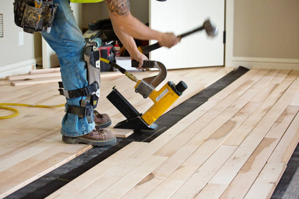 Installation of Maple Hardwood Flooring with Nail Gun in Progress A workman innstalling a maple hardwood floor in a residential home construction. kneepad stock pictures, royalty-free photos & images