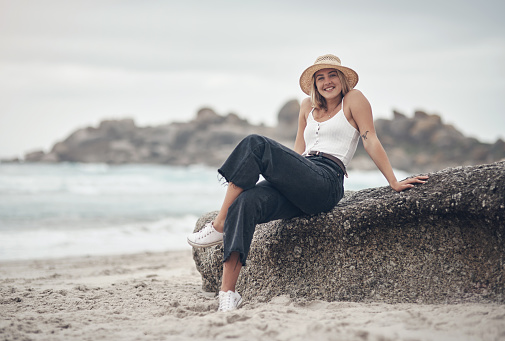 Shot of a beautiful young woman spending the day at the beach