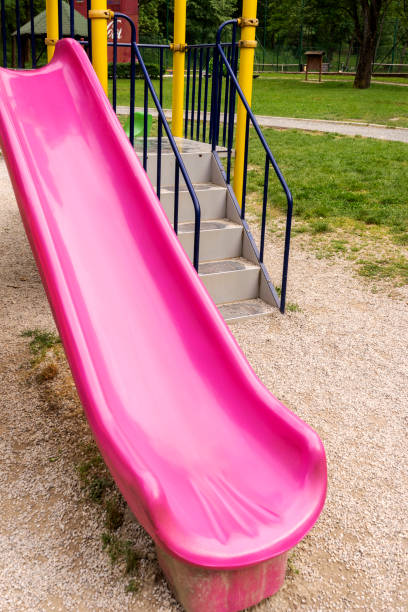 istock Children's playground pink  slide 1303892606