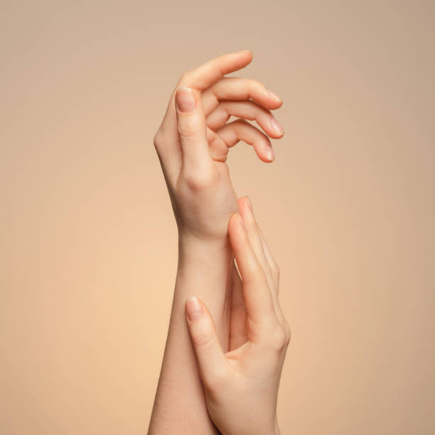 istock A woman's hands close up, on a beige background. 1303892801