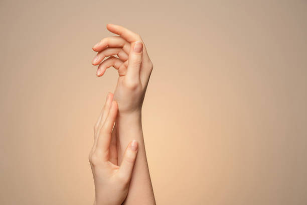 istock A woman's hands close up, on a beige background. 1303892805