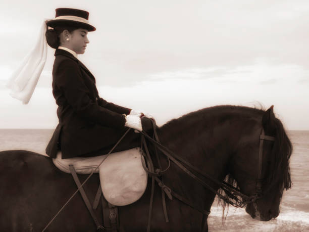 istock Young rider riding her horse on the beach 1303893632
