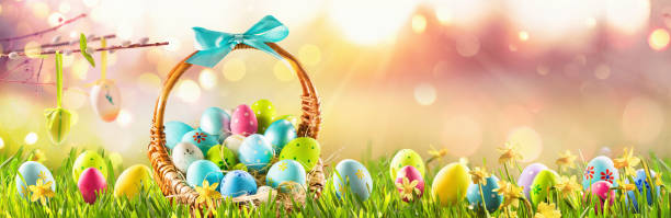 istock Easter Eggs in a Basket on Green Grass Sunny Background 1303894085