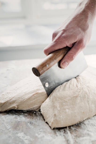 istock Baker Preparing Sourdough Prior to Proving and Baking. 1303894675