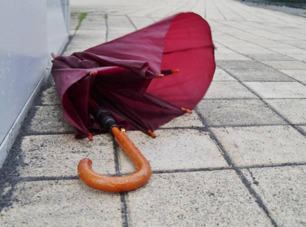 istock Red umbrella lies on the ground 1303894759