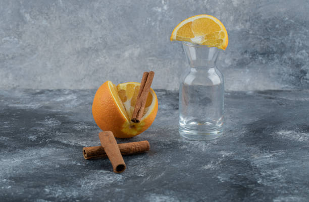 istock Sliced orange fruit with cinnamon sticks and an empty jar 1303896561