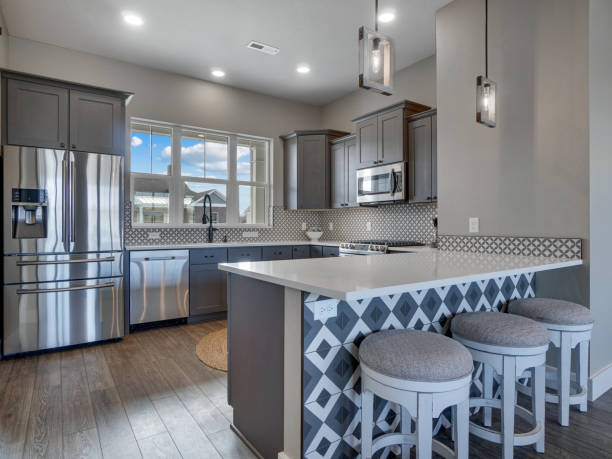 Modern Light and Bright Kitchen Dark Grey Wood Floors with White Countertops Side View