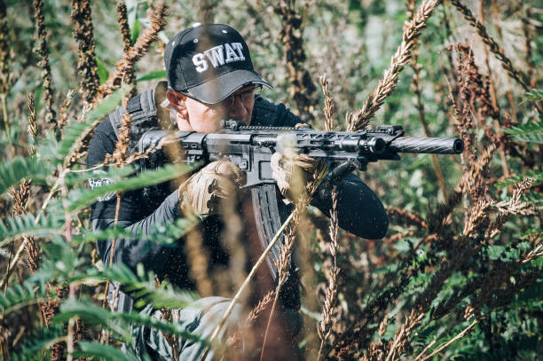istock Army soldier shooting with rifle machine gun in the forest 1303902808