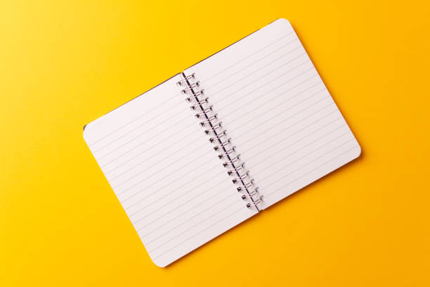 istock Top view of the workspace on yellow background 1303902977
