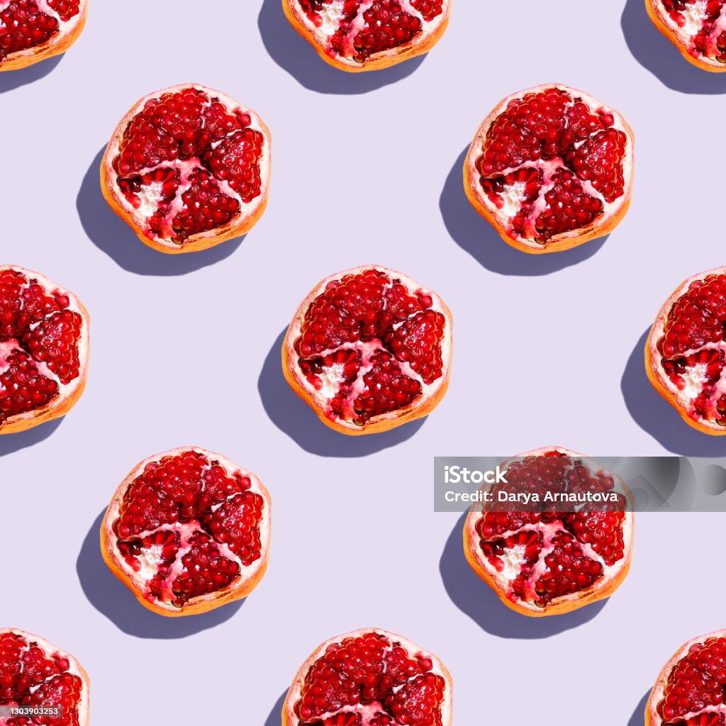 Photography collage of pomegranate on pastel purple lavender color background top view Photography collage of pomegranate on pastel purple lavender color background top view. Isometric food pattern Pomegranate Stock Photo