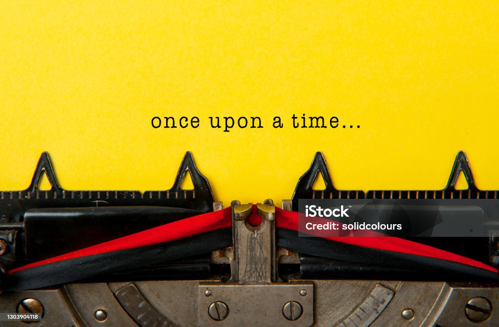 Once Upon A Time Old typewriter with yellow paper. Writing - Activity Stock Photo