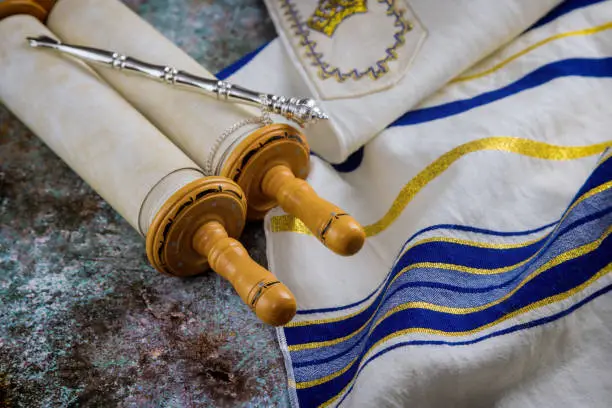 Jewish Orthodox holidays, during prayer items prayer shawl tallit with torah scroll in a synagogue