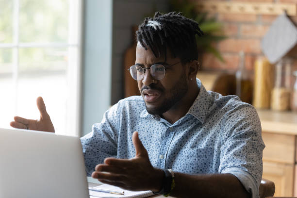 istock Close up angry African American man having problem with laptop 1303905738