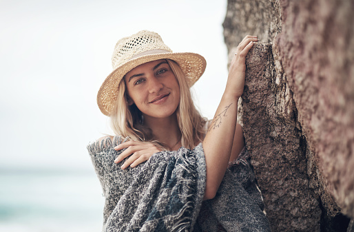 Shot of a beautiful young woman spending the day at the beach