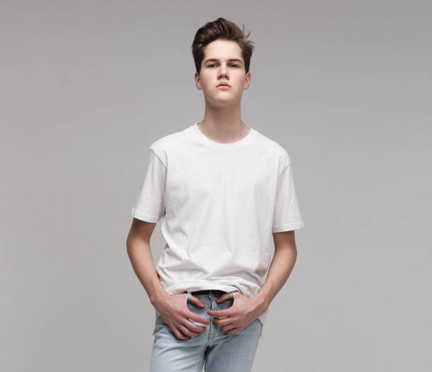 istock Attractive Young Male Model wearing white t-shirt posing in studio 1303908146