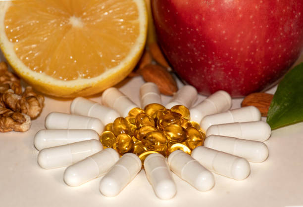 istock Different types of vitamins -  fruits, nuts and pills 1303909458