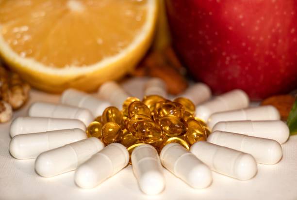 istock Different types of vitamins -  fruits, nuts and pills 1303909495