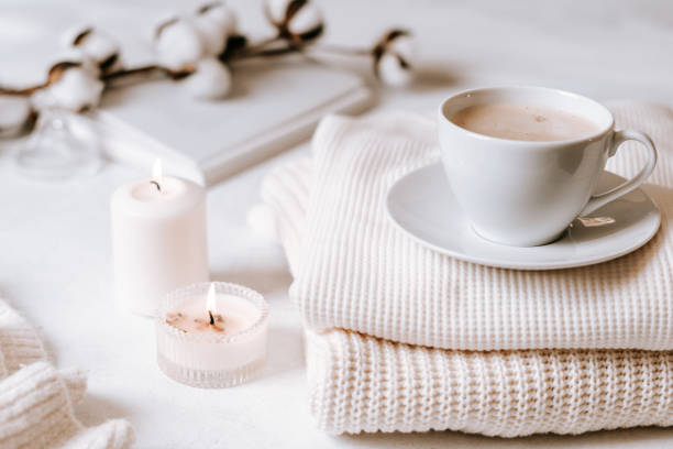 istock White cup of coffee, cotton, candles. 1303909534