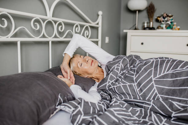 istock Senior woman is sleeping in bed 1303909641