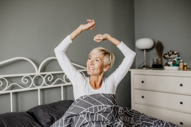 istock Senior woman in bed is waking up 1303909690