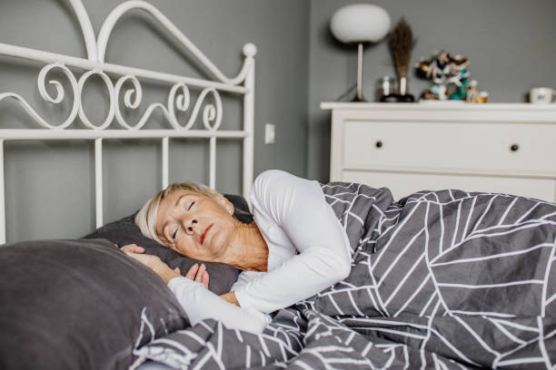 istock Senior woman is sleeping in bed 1303909744