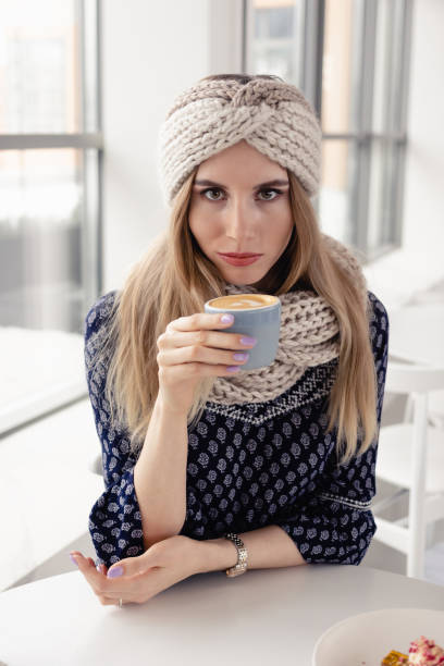 istock girl with hot drink on cafe 1303911042