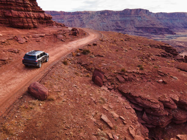 istock Driving SUV Through Red Rock Canyons 1303911286