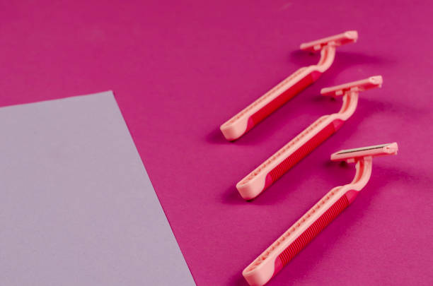 istock Pink plastic razors on a pink background. 1303911379