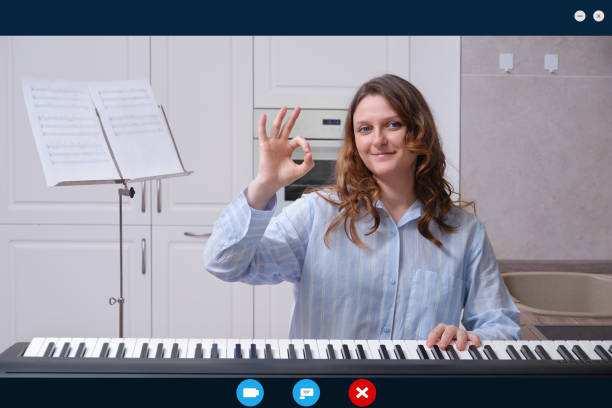 istock A woman plays notes on a musical instruments via a video call. Online learning and remote play of home piano 1303912372