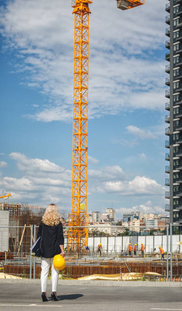 istock Woman construction manager checking works on the construction site 1303912537
