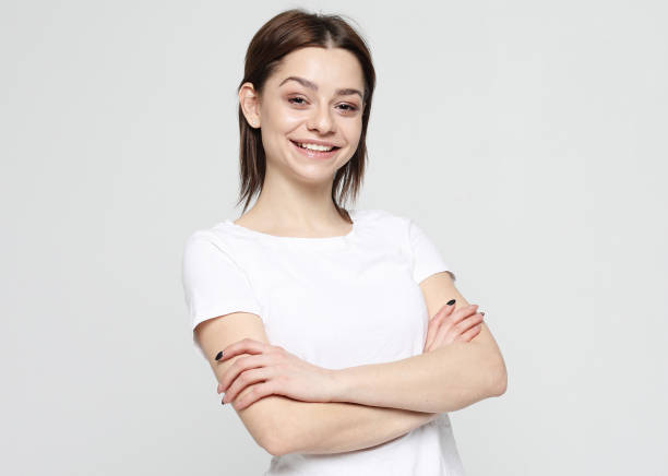 istock good looking young woman smiles positively 1303912954
