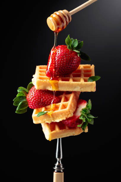 istock Waffles with strawberries and honey. 1303915027